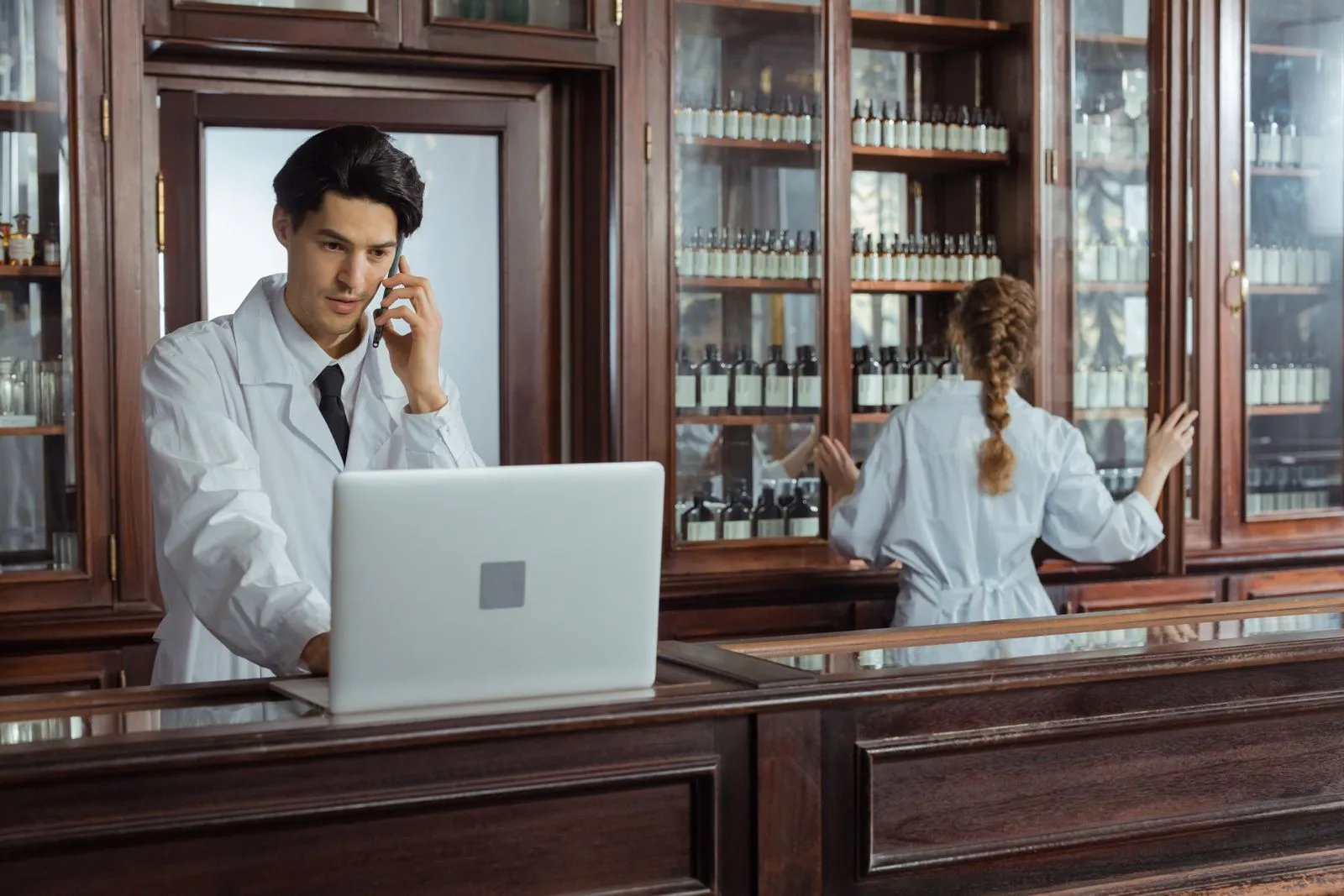Pharmacists working together behind a pharmacy counter